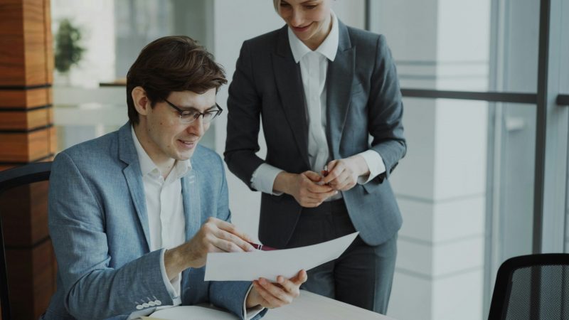 Two business professionals reviewing strategic documents together